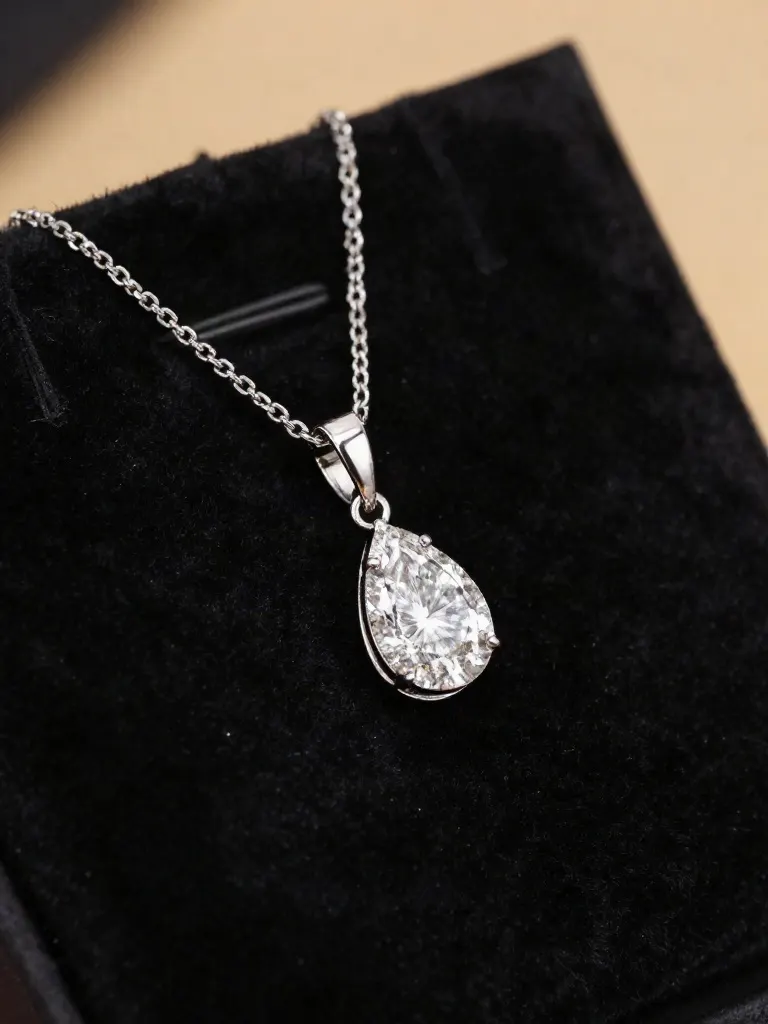 White gold pear diamond pendant on velvet